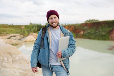 Bearded freelancer hipster combines stay in career with work