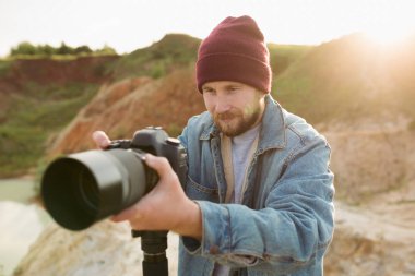 Professional photographer takes a report in the sunset