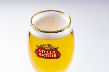 Stella Artois 'in beyaz arka planda bira dolu bardaklarını kapat.