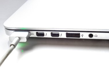 Calgary, Alberta. Kanada mı? 19 Temmuz 2020. Gece görünümü MagSafe 2 güç portu boyunca şarj olan bir MacBook bilgisayarının yan görünümü