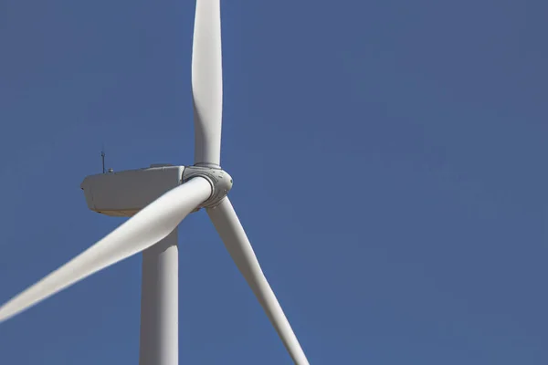 Close up, side view of a wind tower turbine electricity gererator, renewable energy source.