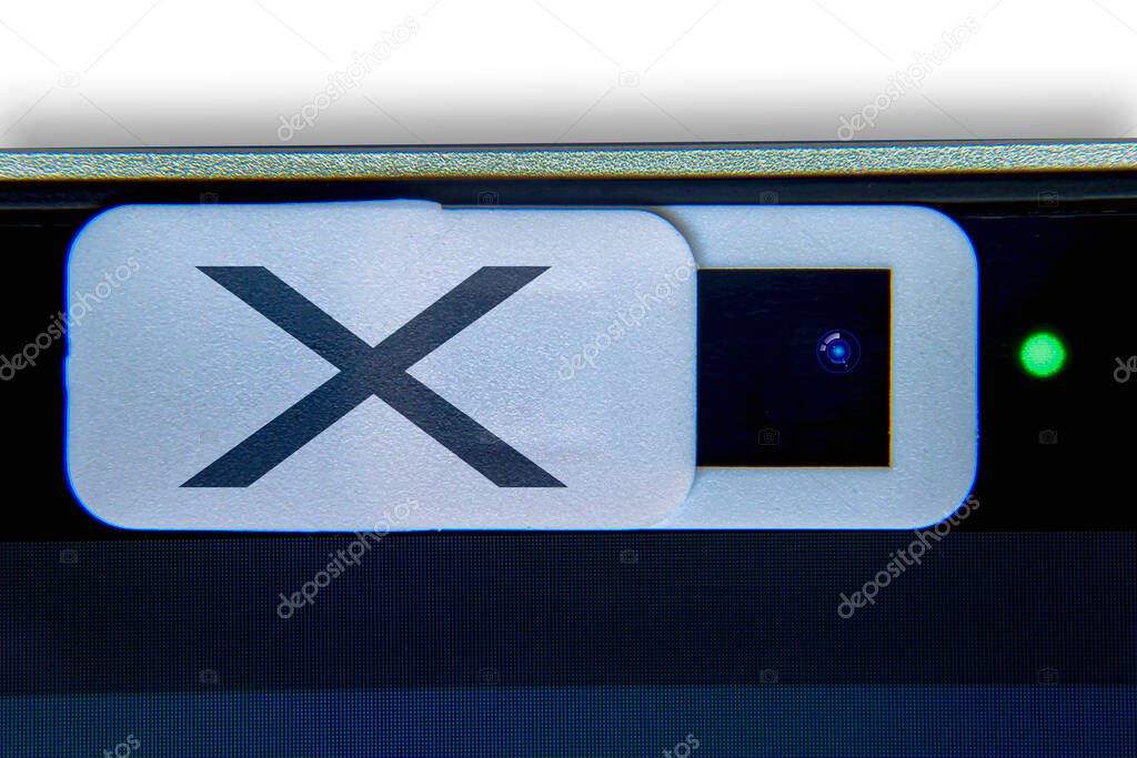 A white camera privacy cover slide with and X on it. Camera web cover for a computer. Concept Computer camera hack privacy.