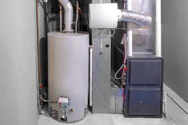 A home high efficiency furnace with a residential gas water heater & humidifier. clipart