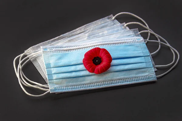 Remembrance Day Poppy Flower with facemask. Concept Remembrance Day during covid-19 pandemic