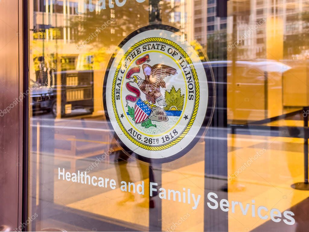 Chicago, Illinois, USA. Sep 11, 2025. A reflection-filled view of the State of Illinois seal on a glass door, with 