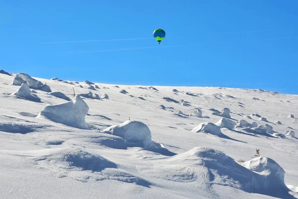 flight with balloon above mountains, beautiful winter