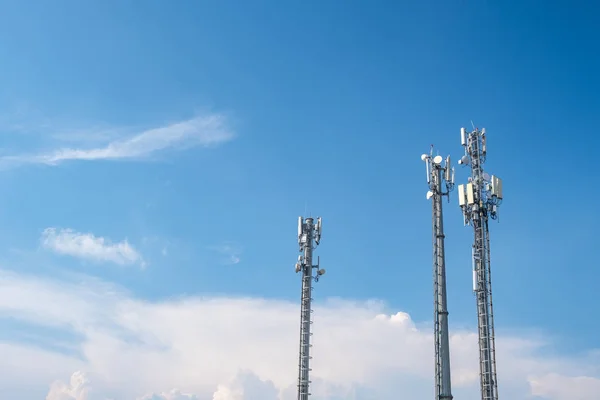 Cellular Base Station or Base Transceiver Station. Telecommunication tower. Wireless Communication Antenna Transmitter. 3G, 4G and 5G Cell Site with cloudy blue sky.