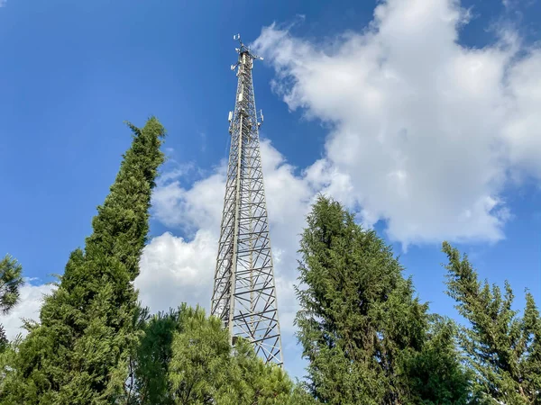 Cellular Base Station or Base Transceiver Station. Telecommunication tower. Wireless Communication Antenna Transmitter. 3G, 4G and 5G Cell Site with blue and cloudy sky.