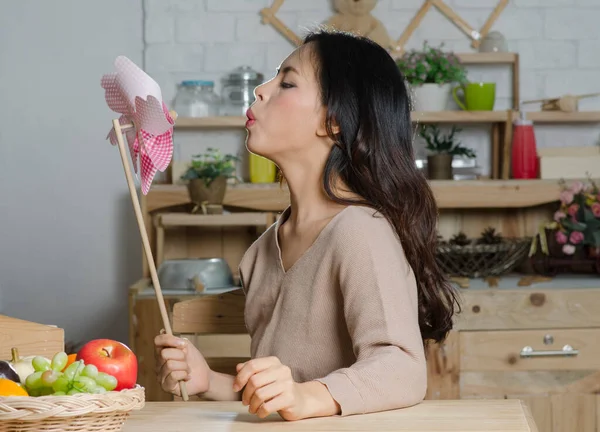 asian young beautiful woman with wind turbine in living room