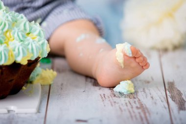 Küçük erkek bebek, mavi arka plan üzerinde atış şut pasta partisi, izole studio ile ilk Doğum günü kutluyor