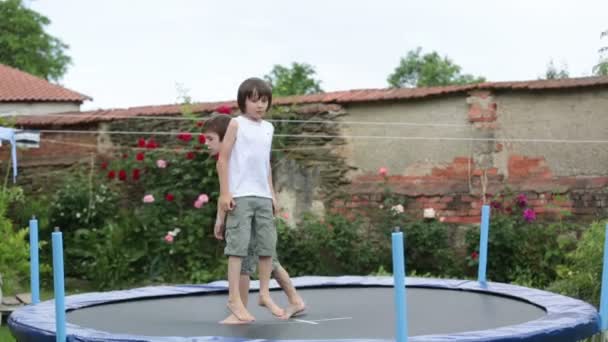 Lindos Niños Hermanos Saltando Trampolín Jardín Verano — Vídeos de Stock