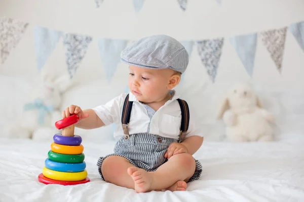 男の子は 日当たりの良い寝室でカラフルなおもちゃで遊ぶ かわいい幼児子供フラグ バナー彼の後ろに装飾 — ストック写真