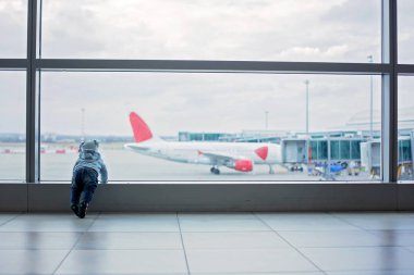 Havaalanında, kalkış bahar uçağını beklerken oynayan küçük çocuk, bebek çocuk,