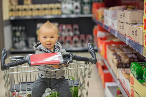 Toddler Baby Boy Sitting Shopping Cart Grocery Store Smiling Eating — Stock Photo, Image