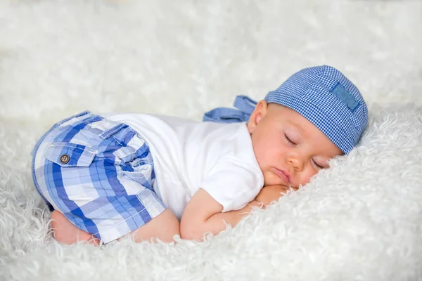 Şapkalı evde yatakta uyuyan sevimli bebek çocuk,