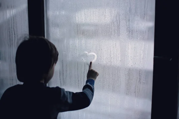 Little Boy Leaving Finger Prints Drawing Hearts Window Home — Stock Photo, Image