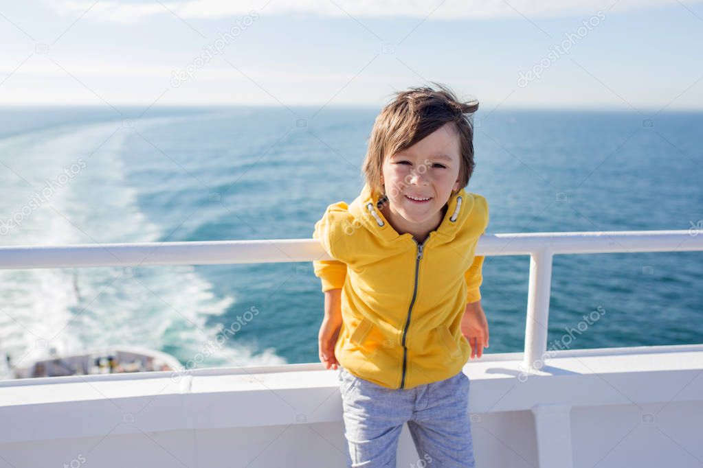 Happy family, traveling on vacation on board of cruise, outdoor on the deck, summertime