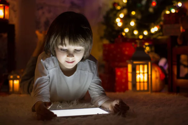 Söt Pojke Liggande Golvet Spelar Tablett Kvällen Juletid Väntar Jultomten — Stockfoto