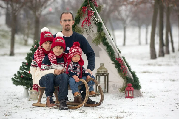 雪の中で楽しい屋外クリスマスを過ごし ティーピー クリスマスの装飾で遊んでいる子供たちと幸せな家族 — ストック写真