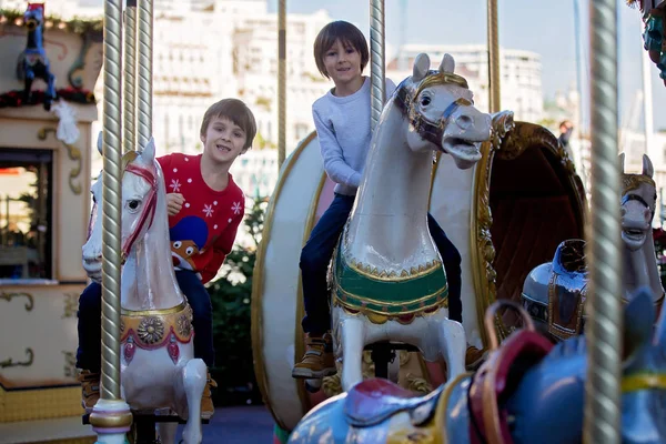 メリーゴーランド カルーセルの地ヨーロッパ アクティブな子供 冬に甘い男の子 サンタ クロースに乗ってそり — ストック写真