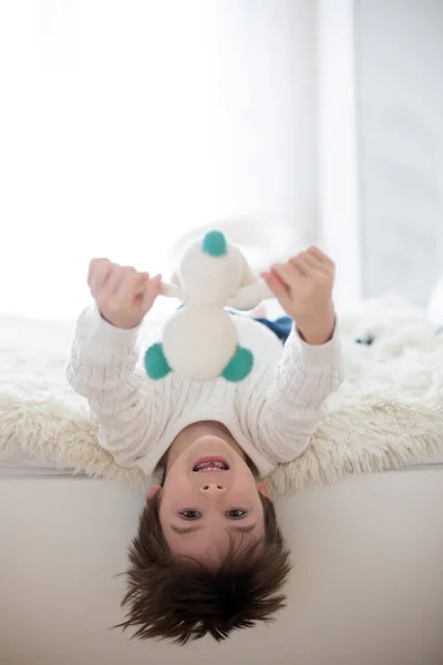 Retrato Bonito Criança Cabeça Para Baixo Deitada Cama Sorrindo Para — Fotografia de Stock