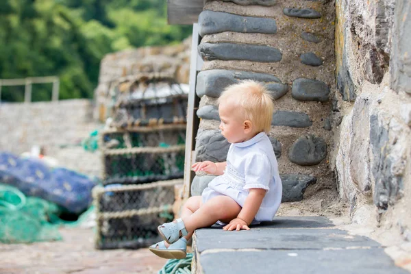 Beautiful baby boy, sitting on the front porch on the streets of — Stock Photo, Image