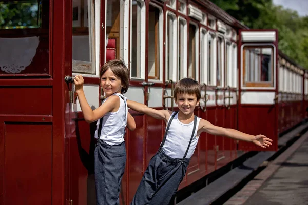 Beautiful children, dressed in vintage clothes, enjoying old ste — Stock Photo, Image