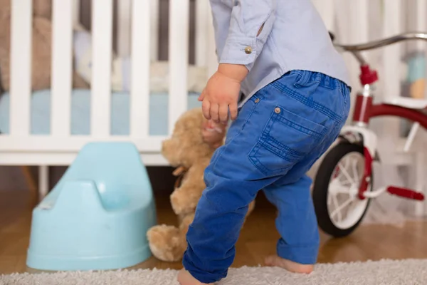 Little toddler child, boy, pee in his pants while playing with