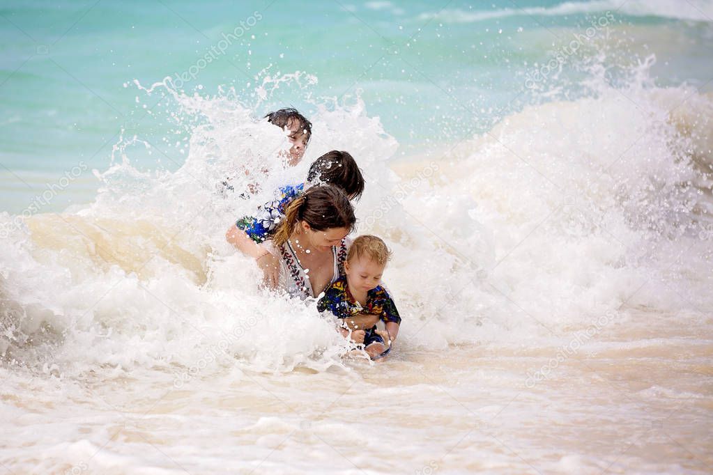 Mother and child playing at tropical beach. Family sea summer va