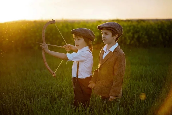 Porträt eines Kindes, das mit Pfeil und Bogen spielt, Bogenschießen schießt eine — Stockfoto