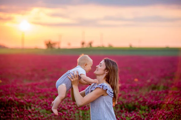 Young mother, embracing with tenderness and care her toddler bab — 스톡 사진