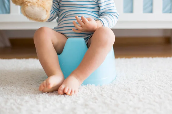 Cute toddler boy, potty training, playing with his teddy bear — Stock Photo, Image