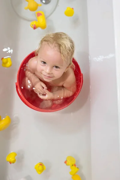 Niño en el baño en el baño. Baño infantil con juguetes y —  Fotos de Stock