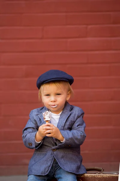 Śliczne dziecko, chłopiec w zabytkowych tkanin, jedzenie lizak lody, si — Zdjęcie stockowe