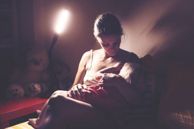 Anne, gece evde onu yürümeye başlayan çocuk emzirme, gece st