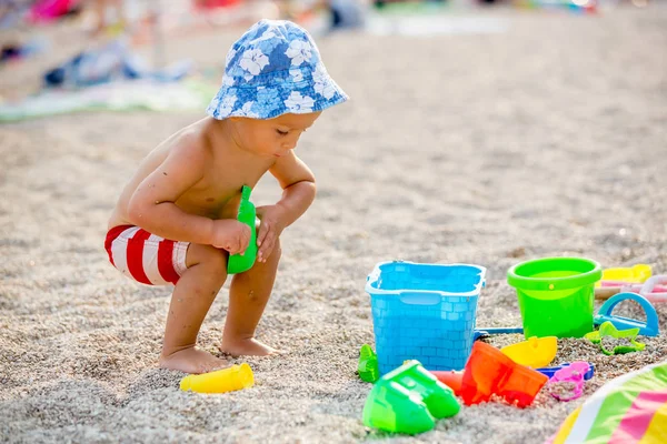 Όμορφη δύο χρόνια παλιό νήπιο παιδί, αγόρι, παίζοντας με την παραλία t — Φωτογραφία Αρχείου