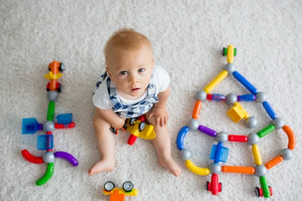 Sweet baby boy, toddler child, playing at home with lots of toys — Stock Photo, Image