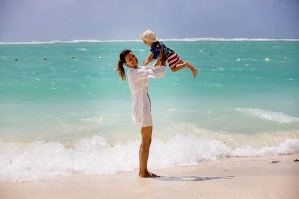 Madre e figlio che giocano alla spiaggia tropicale. Famiglia mare estate va — Foto Stock