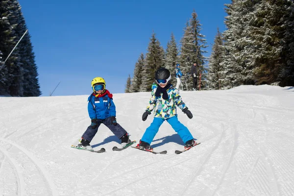 Two young children, siblings brothers, skiing in Austrian mounta — Stock Photo, Image