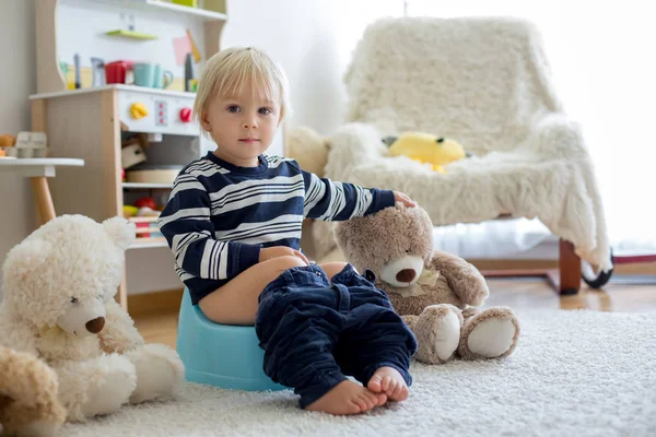 Cute toddler boy, potty training, playing with his teddy bear — Stock Photo, Image