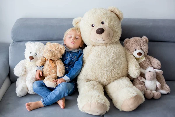 Niño rubio, durmiendo con muchos osos de peluche en el afterno — Foto de Stock