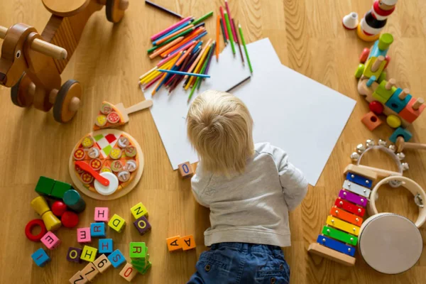 Little blonde toddler boy, drawing with pastels and coloring pen — Stock Photo, Image