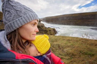 Mother with children, enjoying the big majestic Gullfoss waterfa clipart