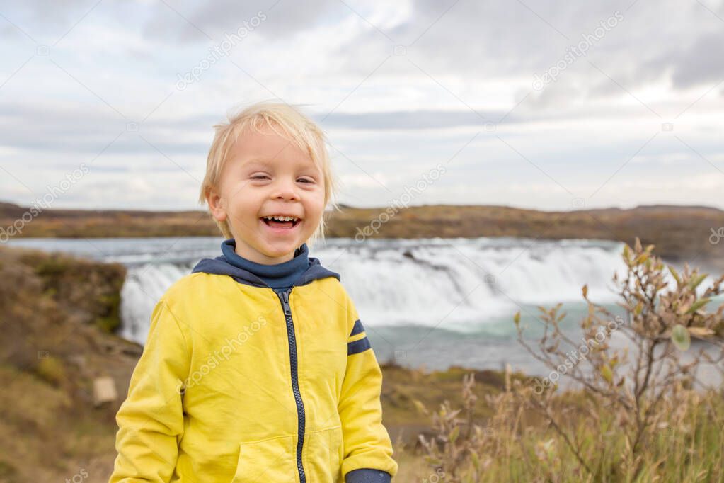 Portrait of a smiling baby boy near smaller waterfall around Gul