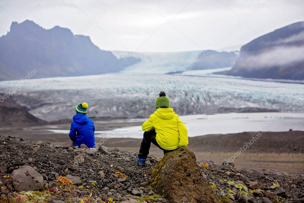 Children posing in beautiful aerial view of the nature in Skafta