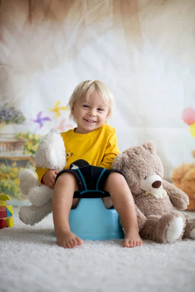 Cute toddler boy, potty training, playing with his teddy bear — Stock Photo, Image