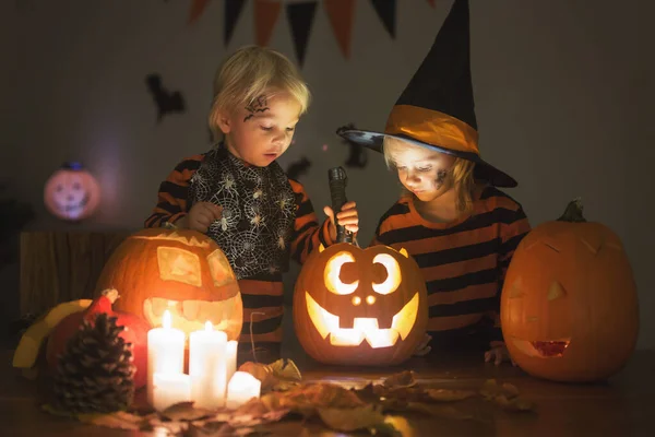 Adorable children, toddler boy and girl, playing with Halloween — Stock Photo, Image