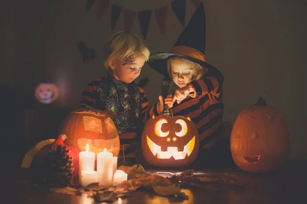 Sevimli çocuklar, küçük bir çocuk ve kız, Cadılar Bayramı 'yla oynuyorlar. — Stok fotoğraf