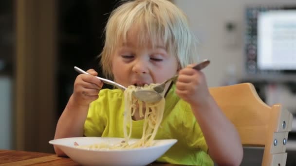 可爱的金发男孩 孩子在家里用手吃意大利面 — 图库视频影像