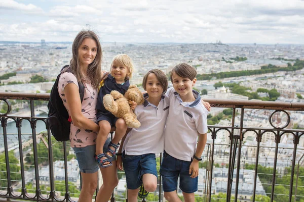 Happy family with children, visiting Paris during the summer